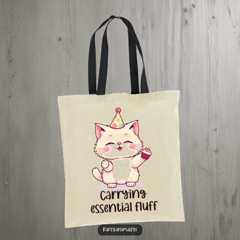 Funny Tote Bag with a fluffy cat in a party hat, expertly juggling small cupcakes.