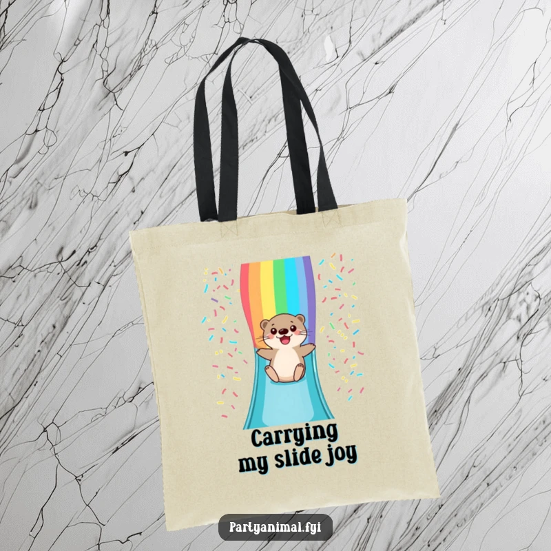 Funny tote bag featuring a happy otter character sliding down a bright rainbow confetti slide, perfect for carrying joy and essentials.